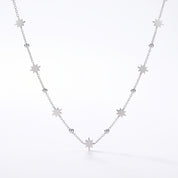 Silver chain with starburst charms and polished beads on white