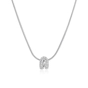 Silver bubble letter necklace on a snake chain, laid on white