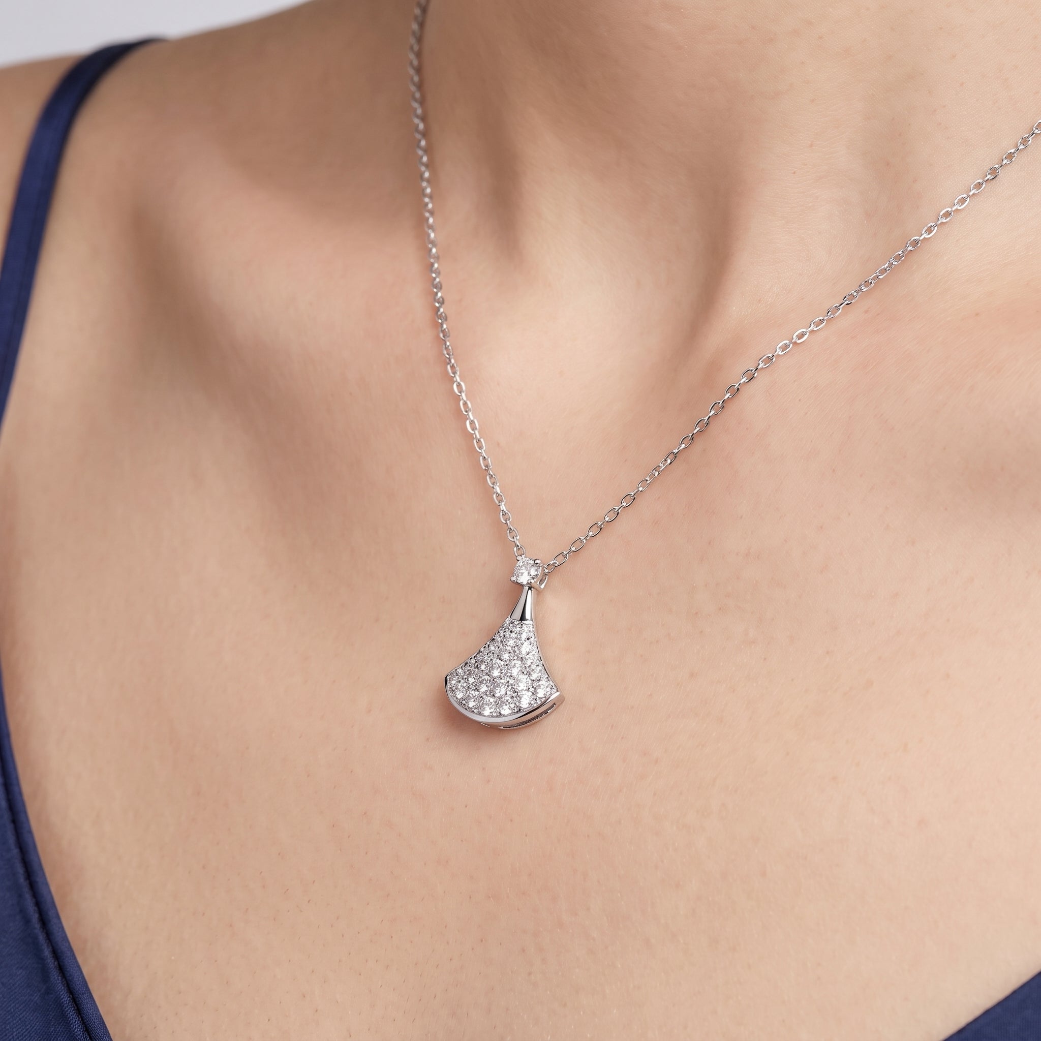 Close-up of a cubic zirconia pavé pendant on a fine silver chain
