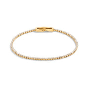Slim gold crystal tennis bracelet with box clasp on white