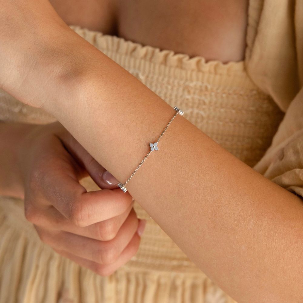 Silver blue clover bracelet fastened on the wrist