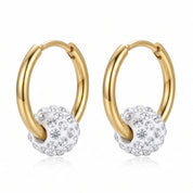 Pair of gold hoop earrings with crystal ball charms on white