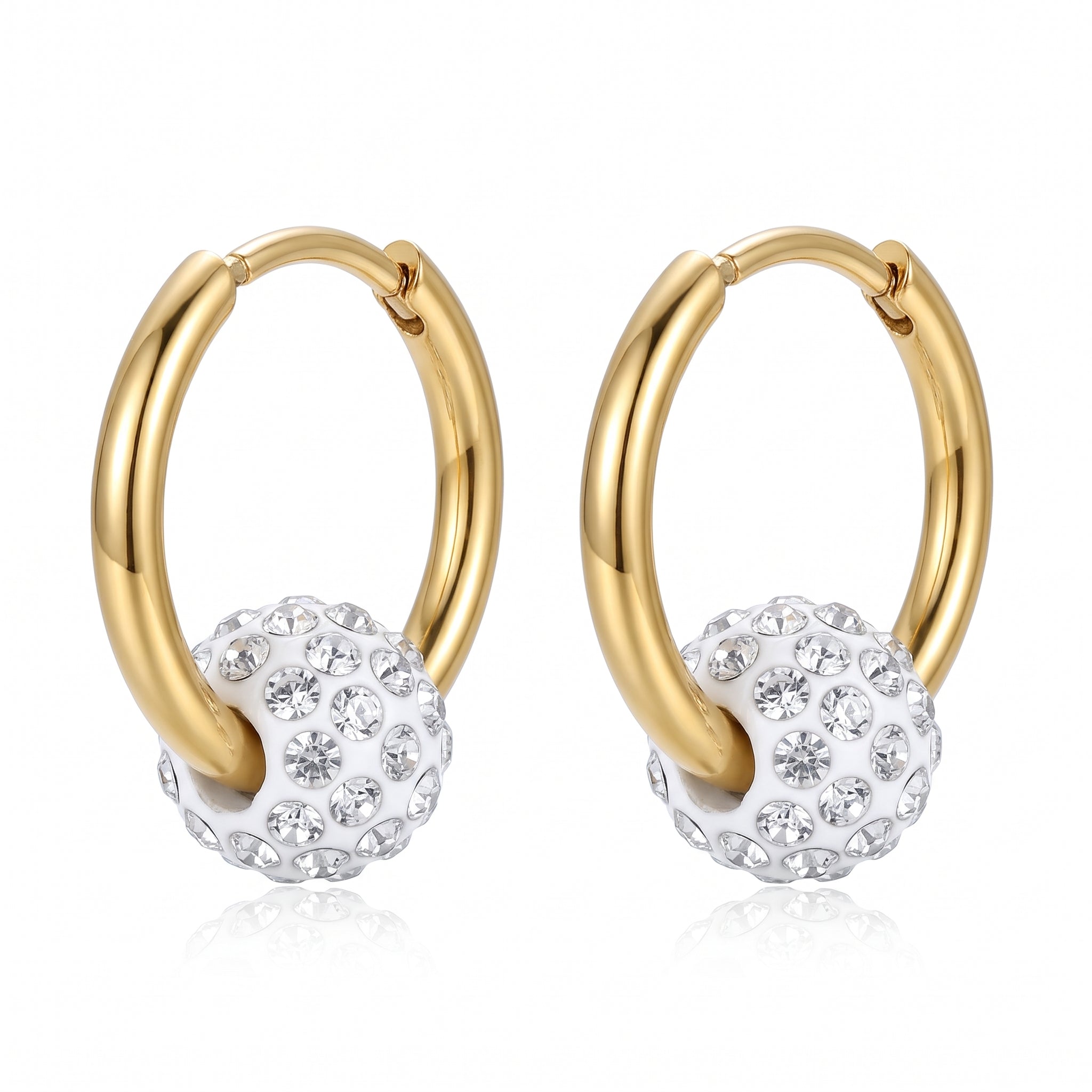 Pair of gold hoop earrings with crystal ball charms on white