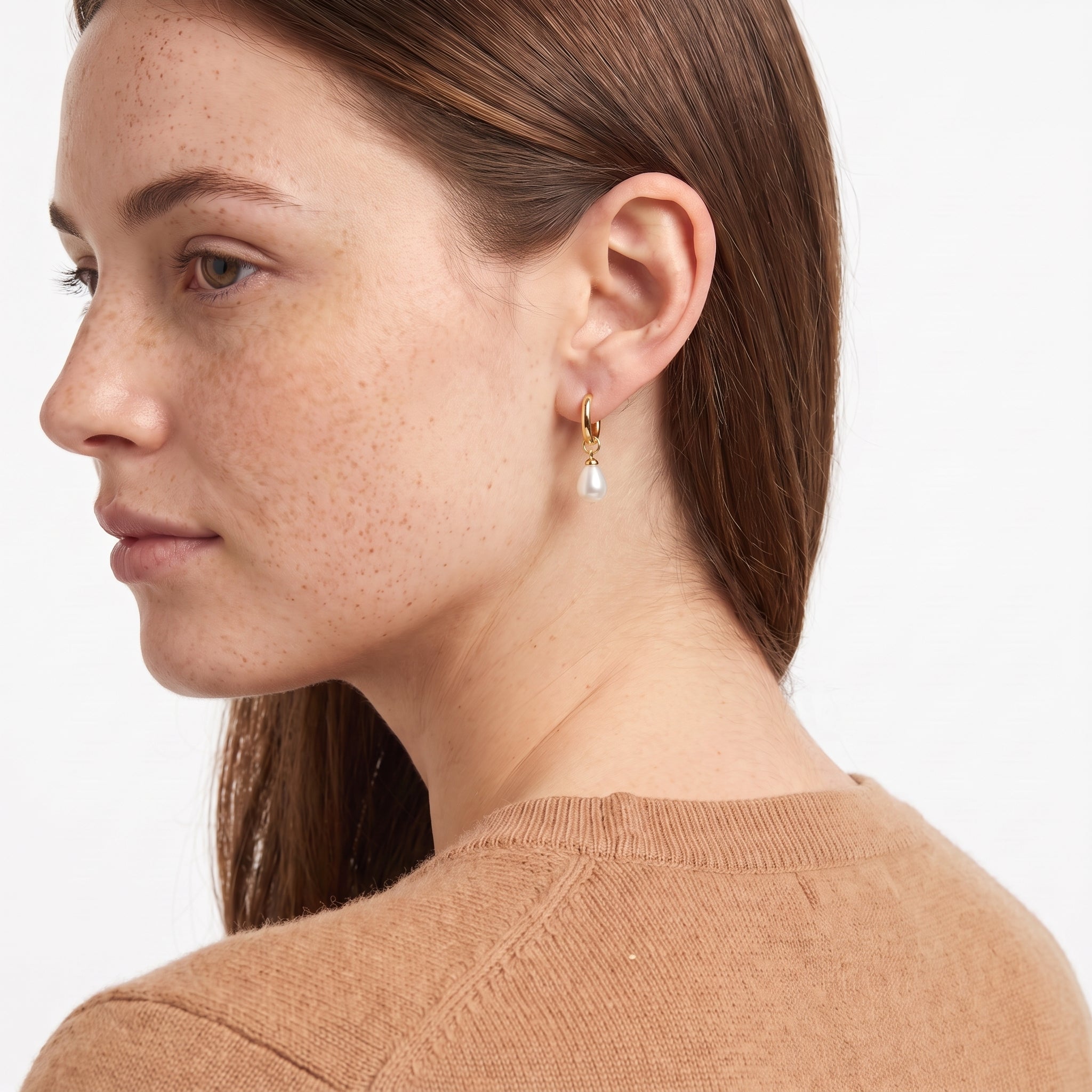 Woman in camel sweater seen from behind wearing Odile pearl drop hoop earring