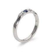 Silver three stone ring with blue and clear crystals on white