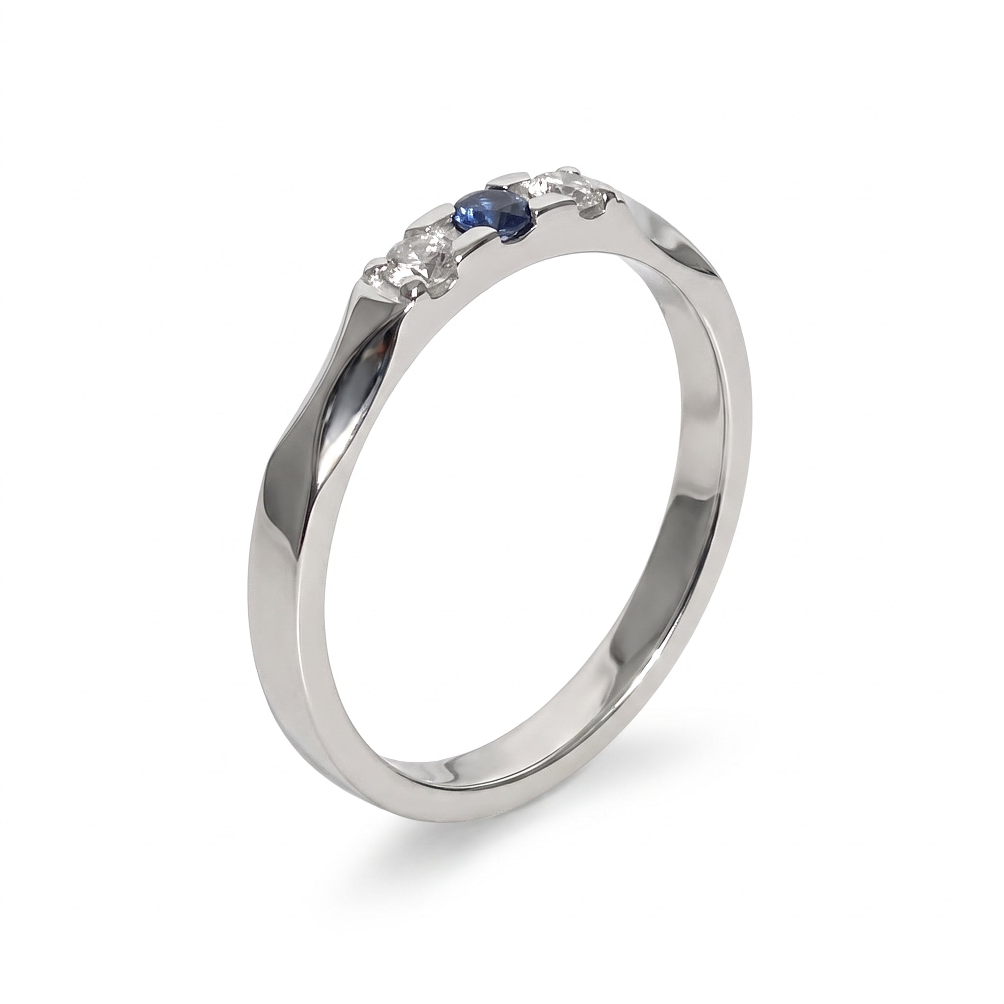 Silver three stone ring with blue and clear crystals on white