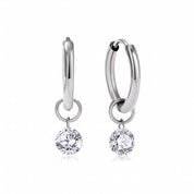 Pair of silver huggie earrings with round crystals on white