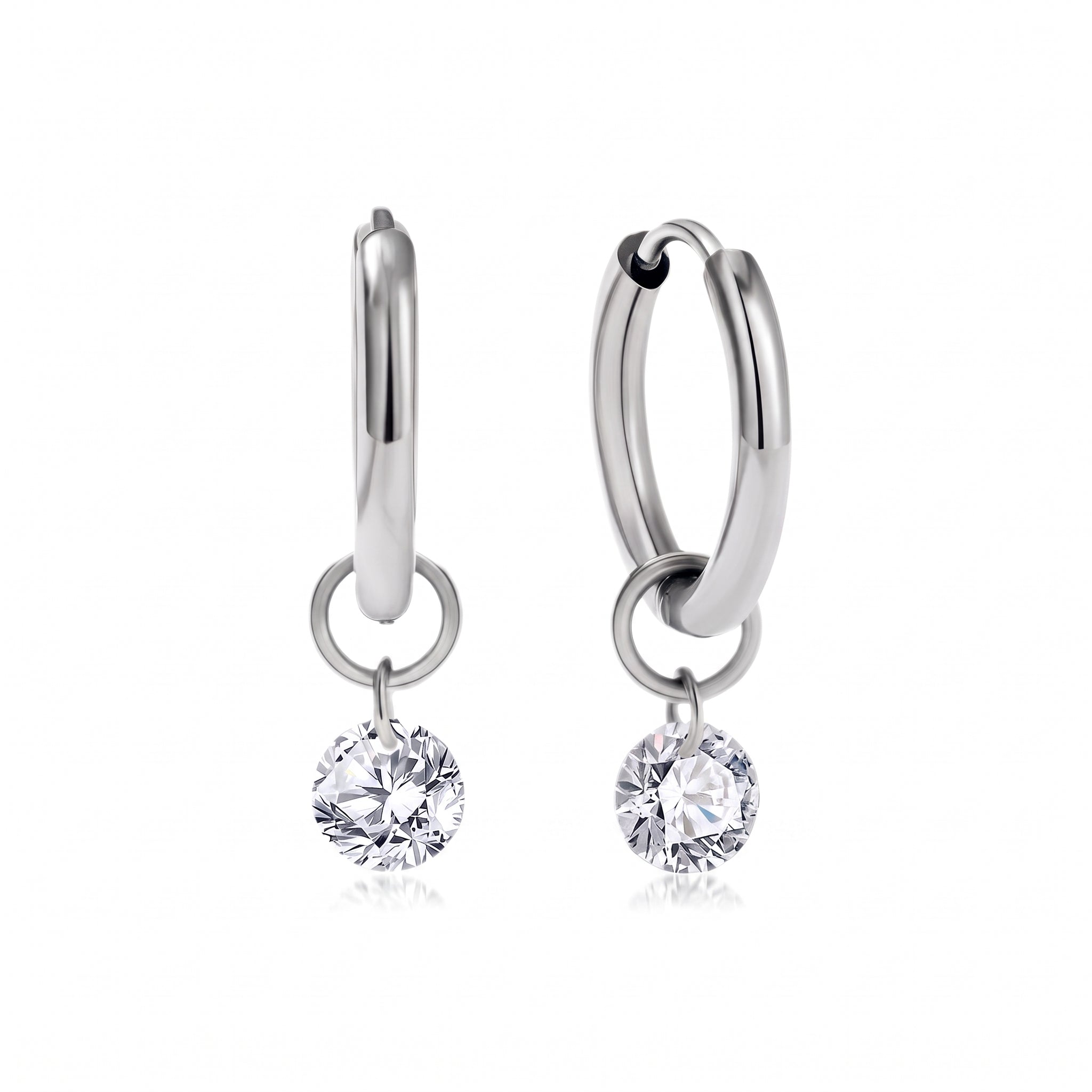 Pair of silver huggie earrings with round crystals on white