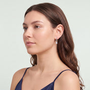 Silver teardrop huggie earring in a serene chin lift
