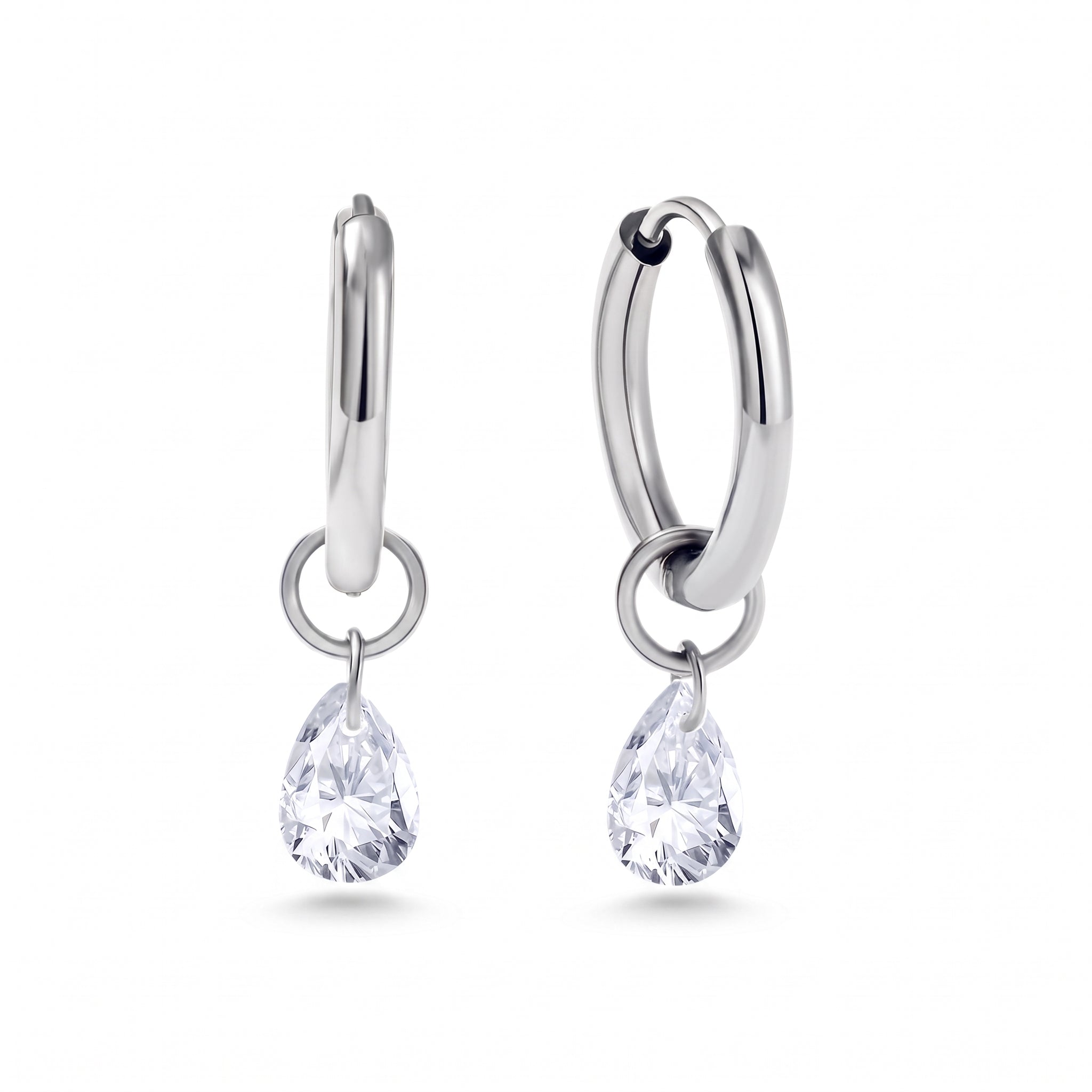 Pair of silver huggie earrings with teardrop crystals on white