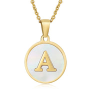 Gold initial disc necklace with letter A on a round mother of pearl pendant