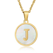 Perrine gold initial disc necklace, letter J on mother of pearl