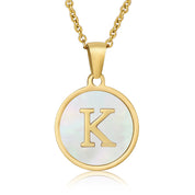 Perrine gold initial disc necklace, letter K on mother of pearl