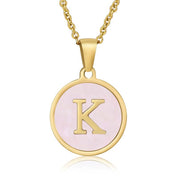 Perrine pink initial disc necklace, letter K on pink mother of pearl