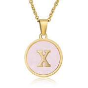 Perrine pink initial disc necklace, letter X on pink mother of pearl
