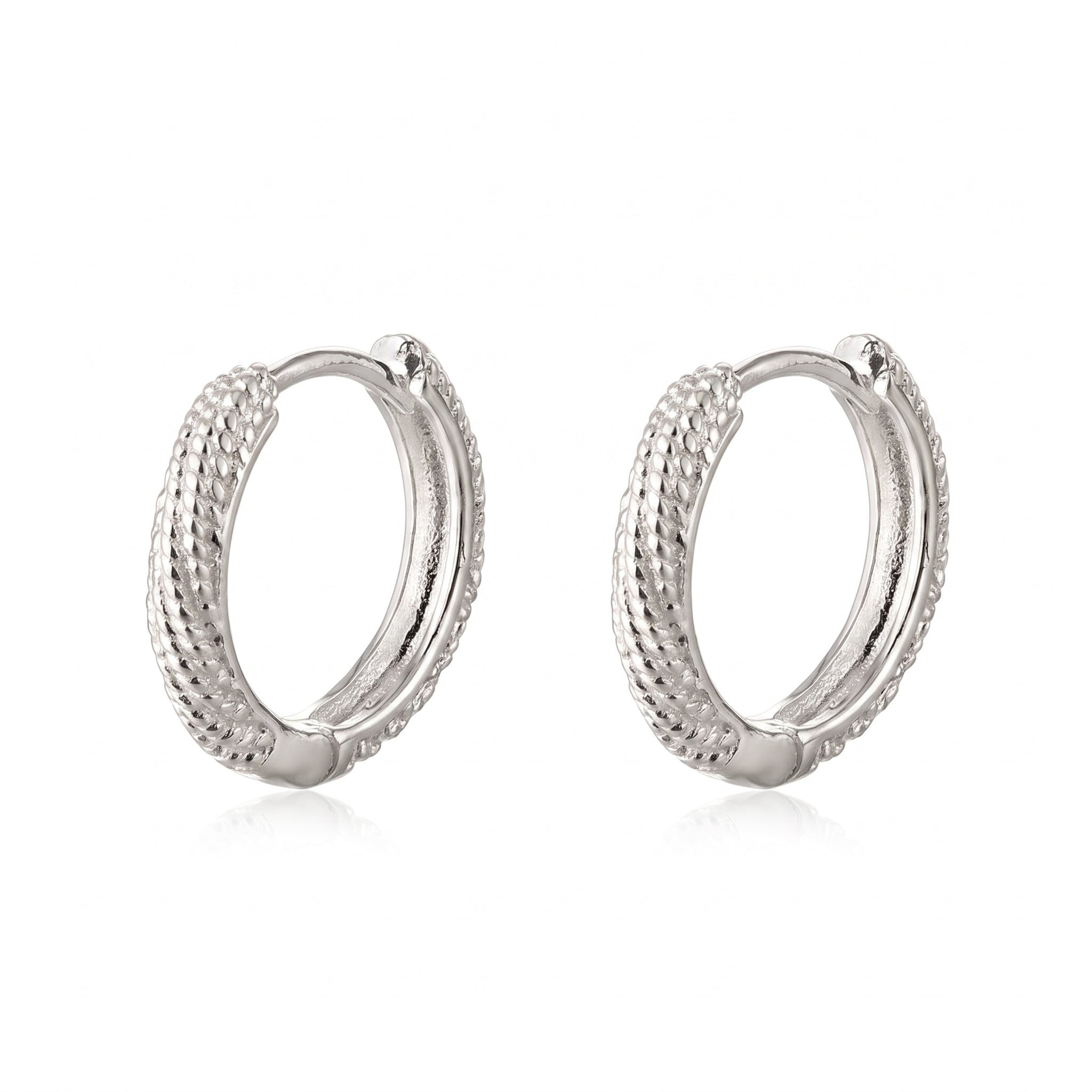 Silver rope huggie earrings as a pair on white