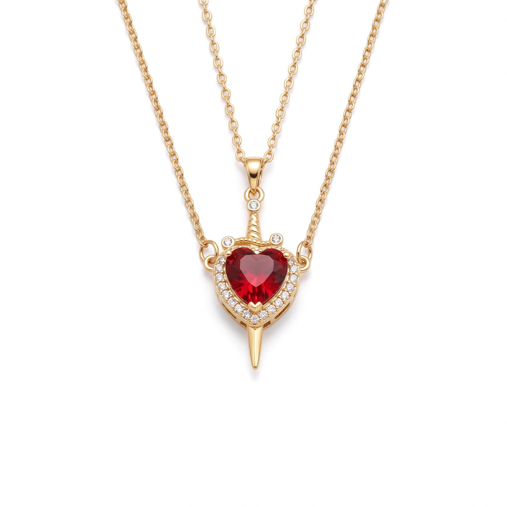 Gold heart and sword necklace laid out on a white background