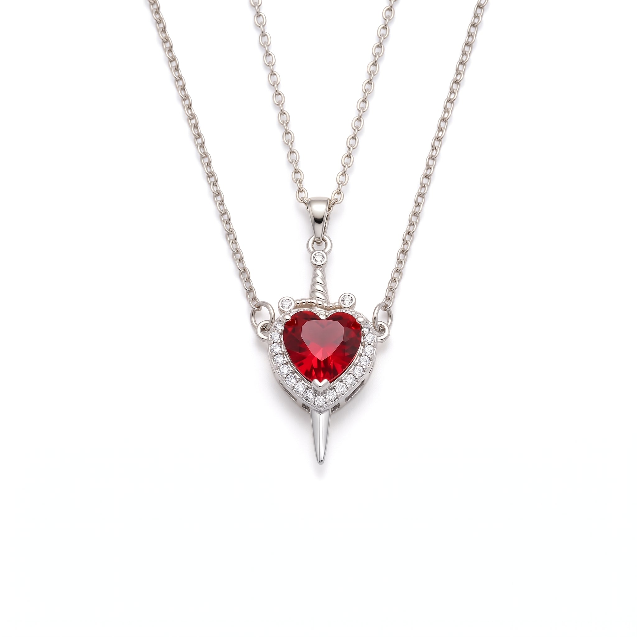 Silver heart and sword necklace laid out on a white background