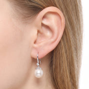 Ear wearing Navalli silver pearl drop earring Sabine with crystal-lined hook