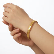Gold hammered cuff bracelet on the wrist