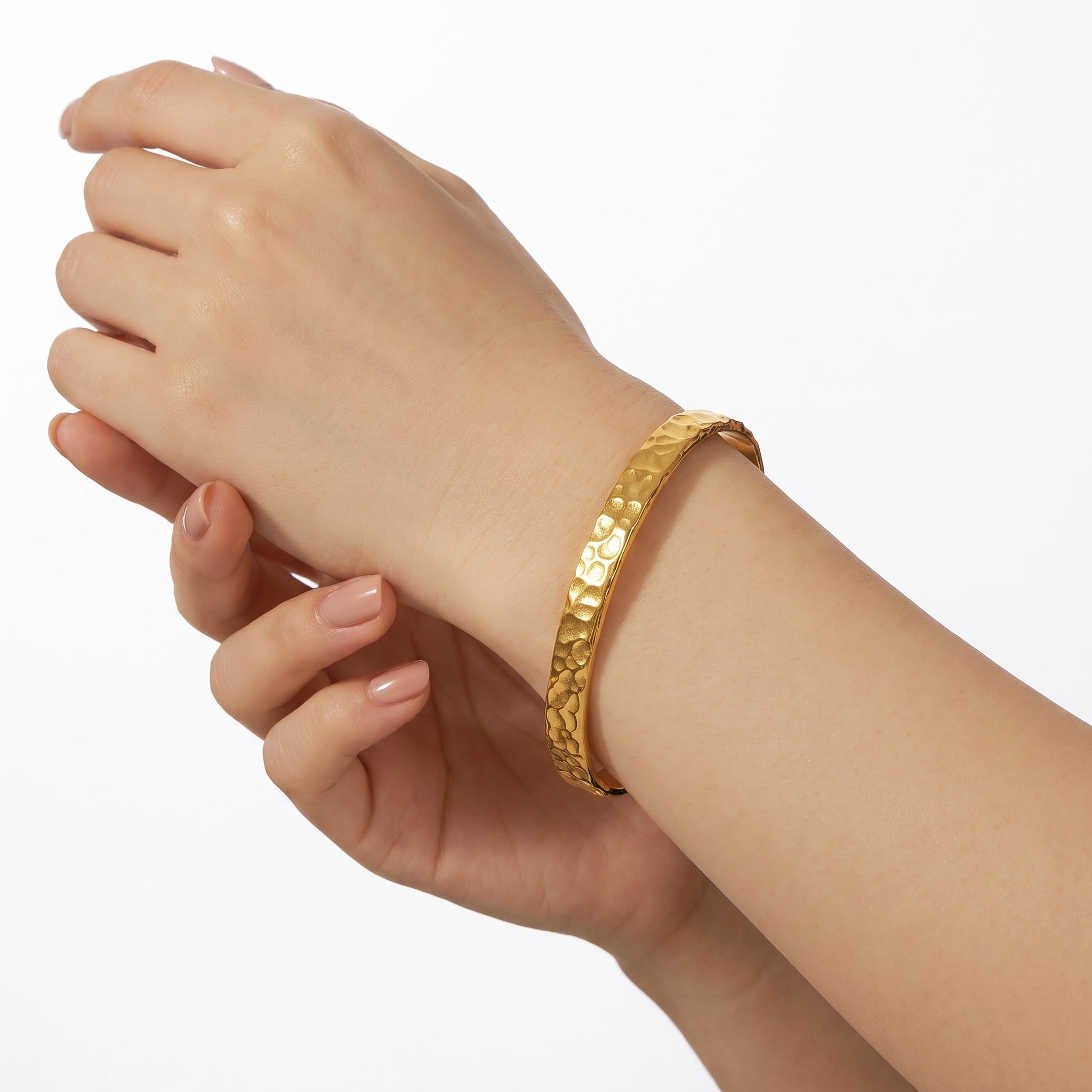 Gold hammered cuff bracelet on the wrist