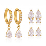 Gold earring set: huggie hoops and two pairs of crystal studs