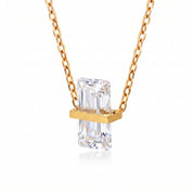 Gold birthstone necklace with a clear rectangular crystal
