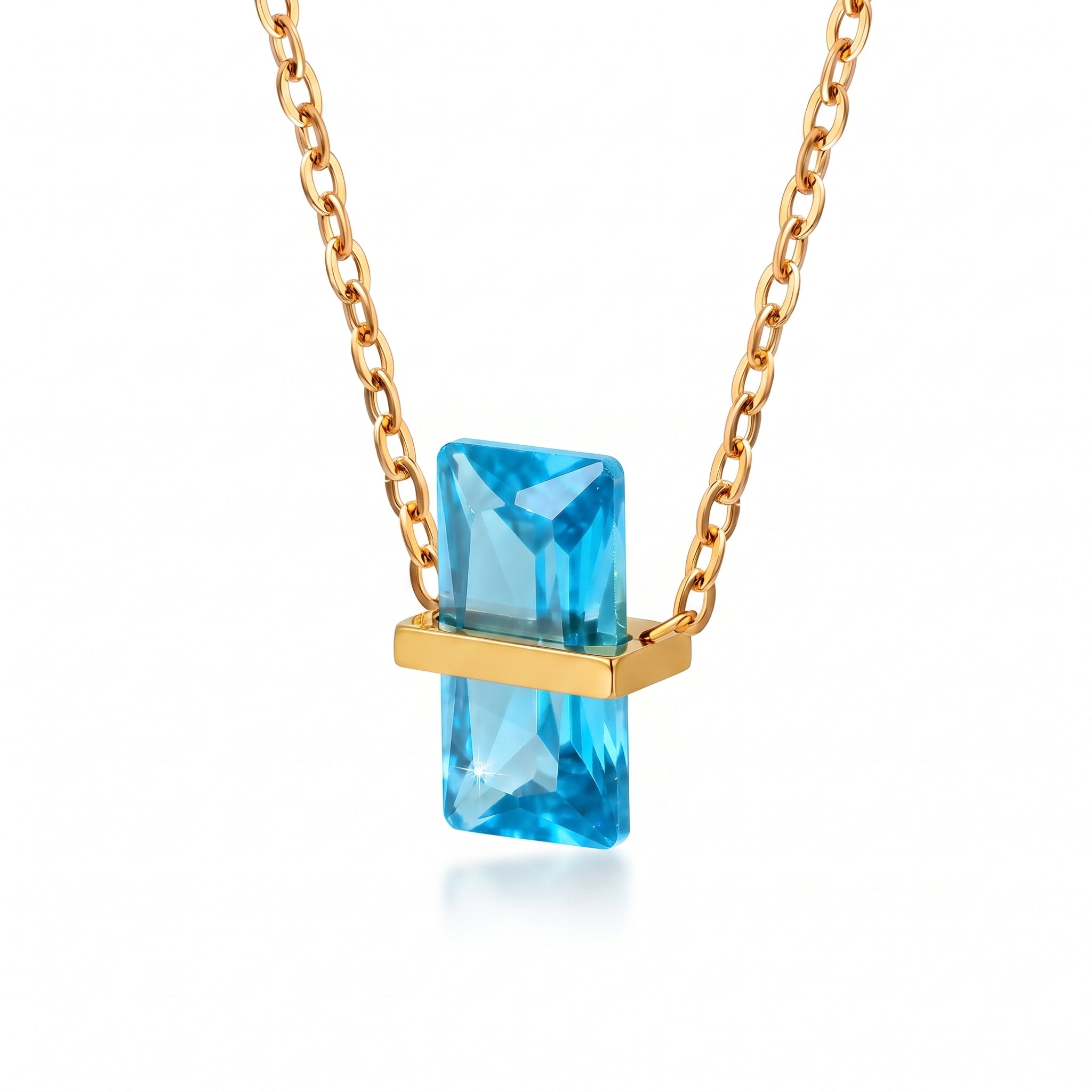 Gold birthstone necklace with a sky blue rectangular crystal
