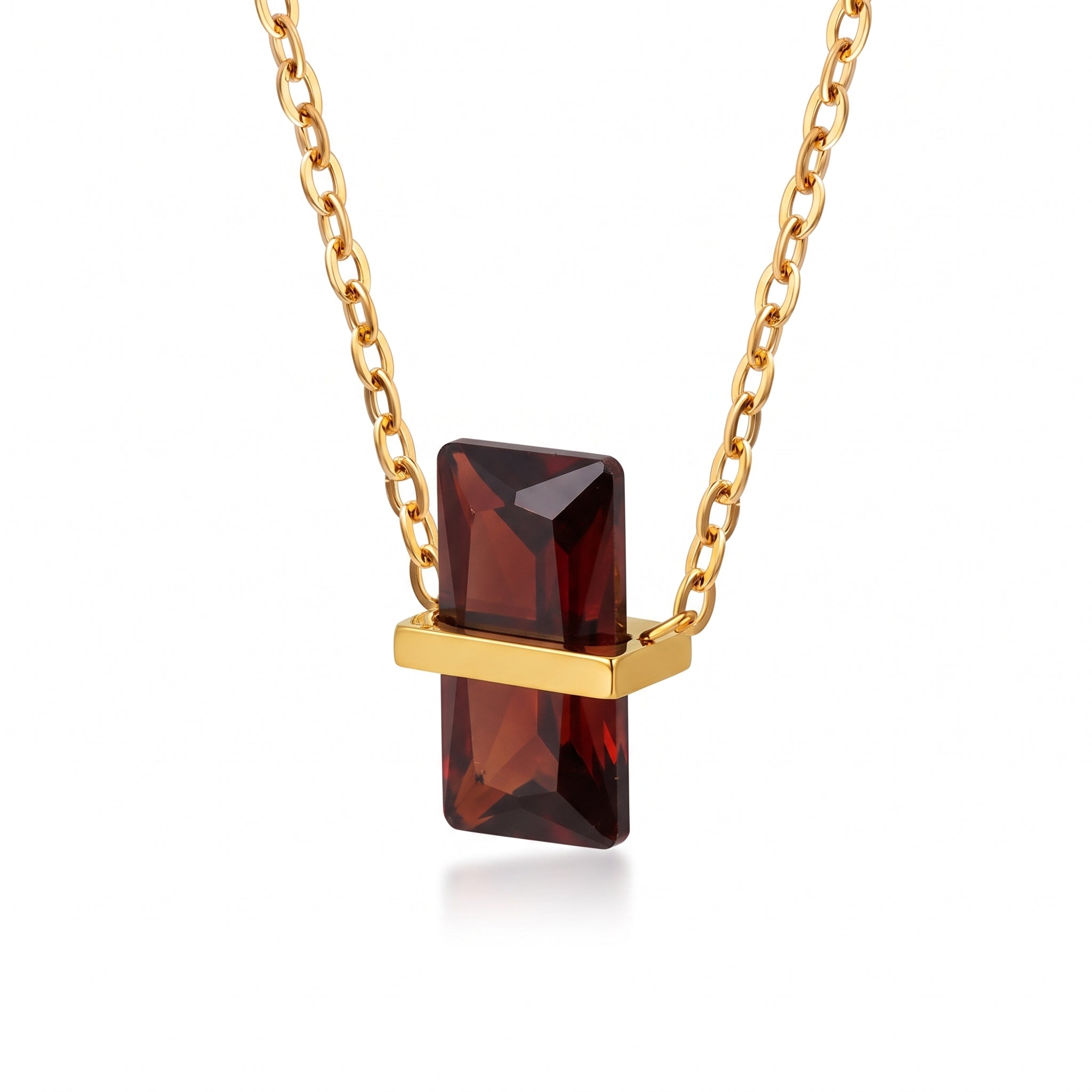 Gold birthstone necklace with a deep red rectangular crystal pendant