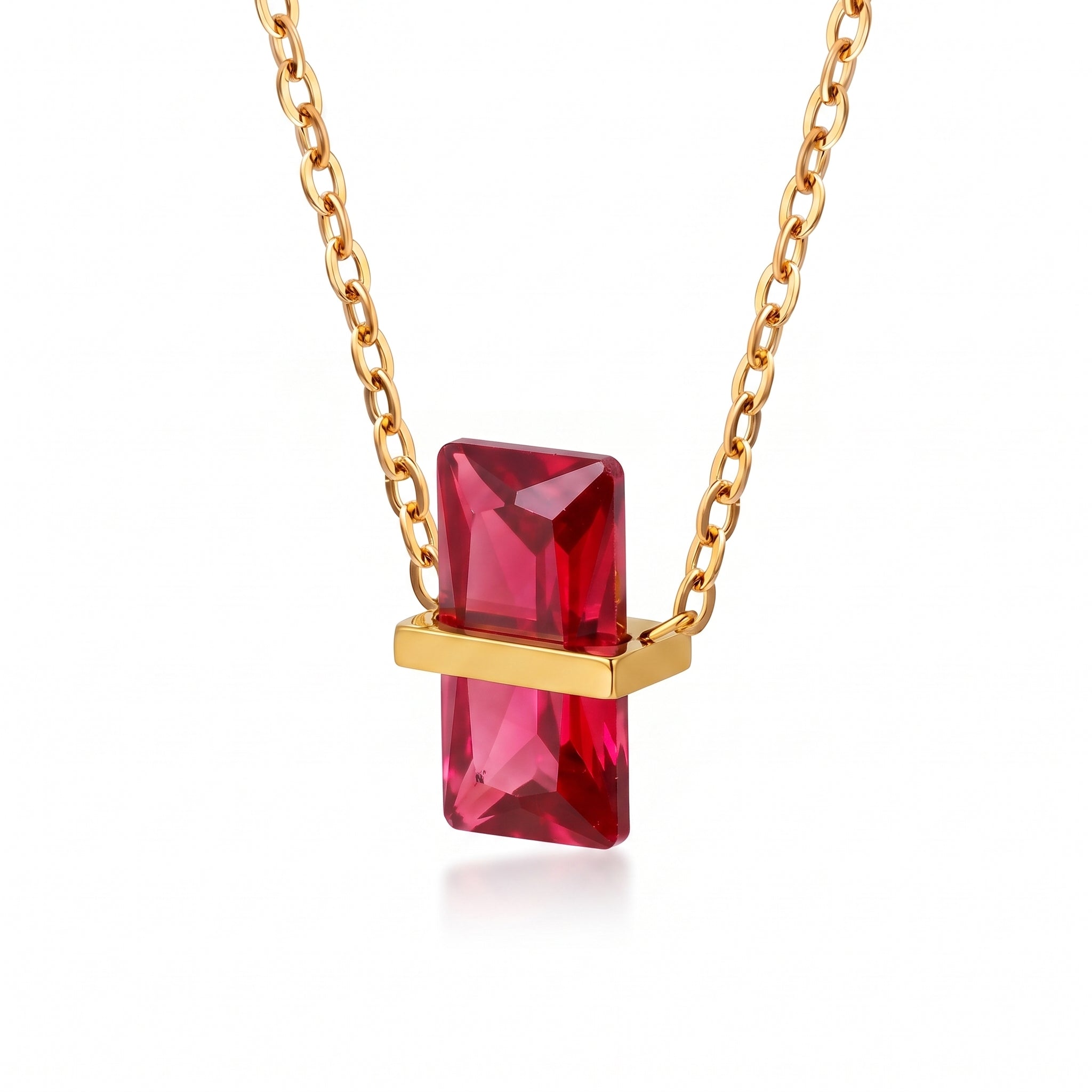 Gold birthstone necklace with a bright red rectangular crystal