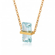 Gold birthstone necklace with a pale aqua rectangular crystal