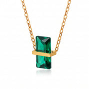 Gold birthstone necklace with a green rectangular crystal