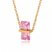 Gold birthstone necklace with a pink rectangular crystal