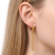 Gold ball chain tassel earrings worn on the earlobe