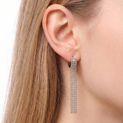 Silver ball chain tassel earrings worn on the earlobe