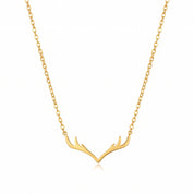 Gold antler necklace with cable chain, laid on white