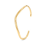 Gold open cuff bracelet with a gentle curve on a white background