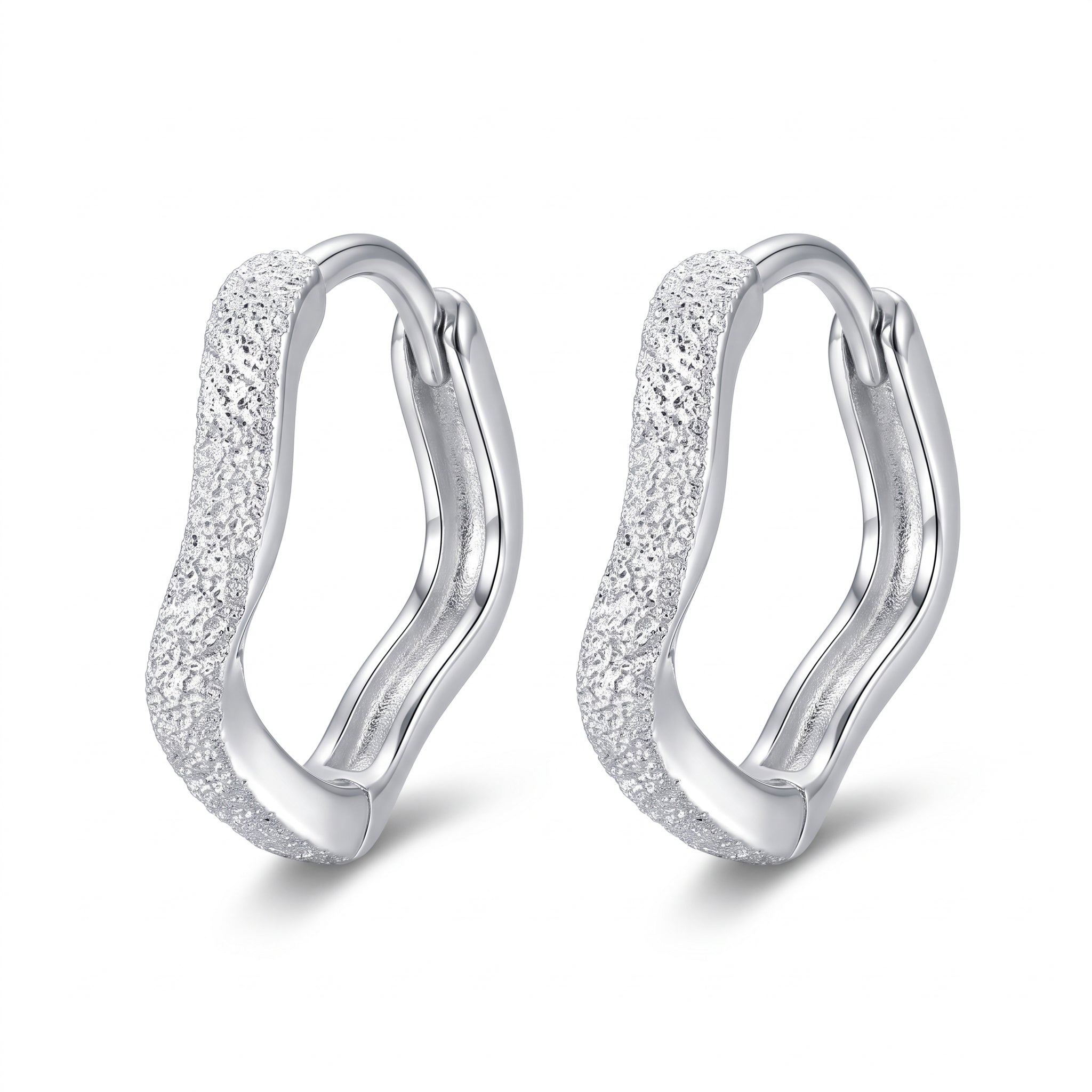 Silver frosted wavy huggie earrings side by side on white