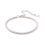 Silver tennis bracelet with a slim row of crystals on white